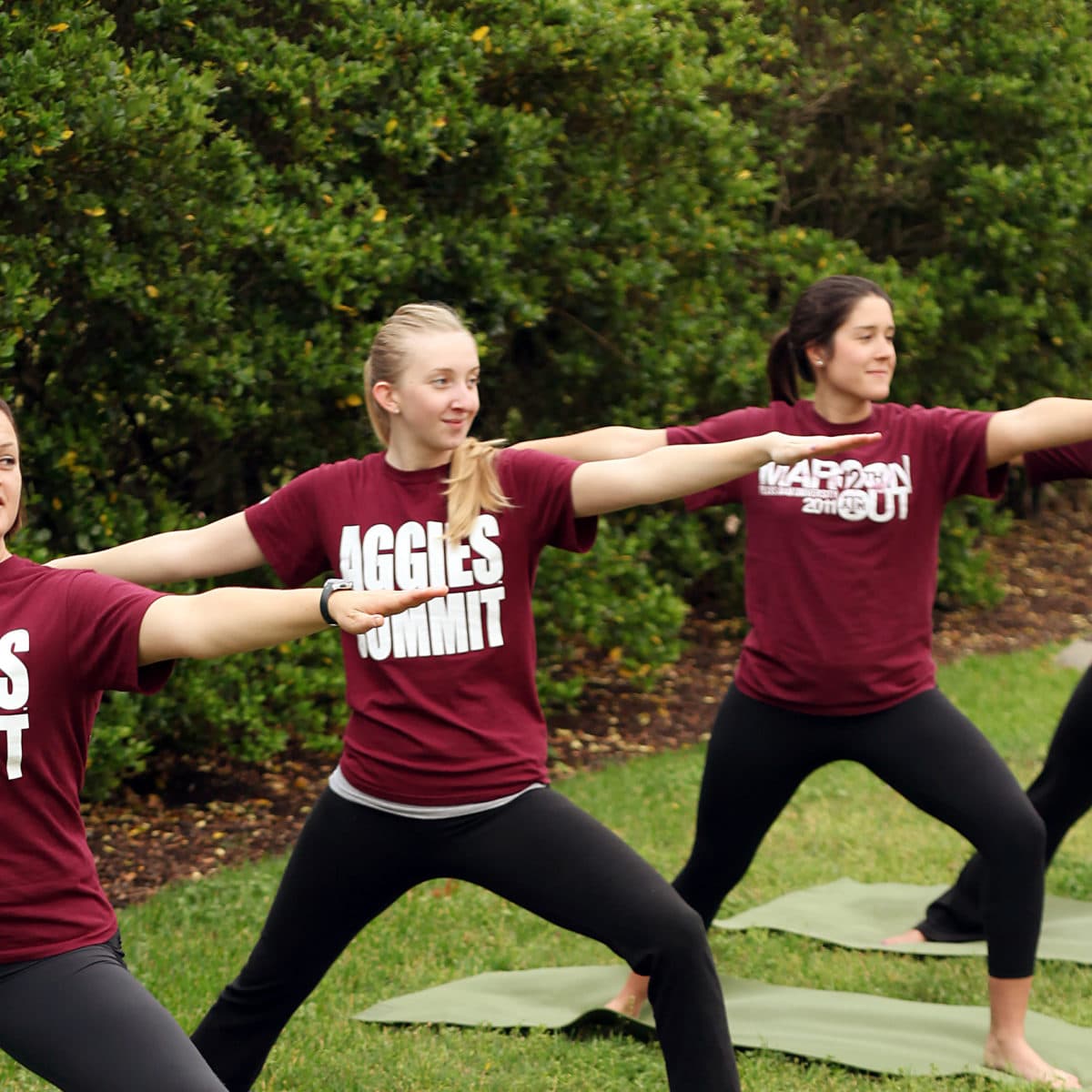 Aggies performing yoga outside